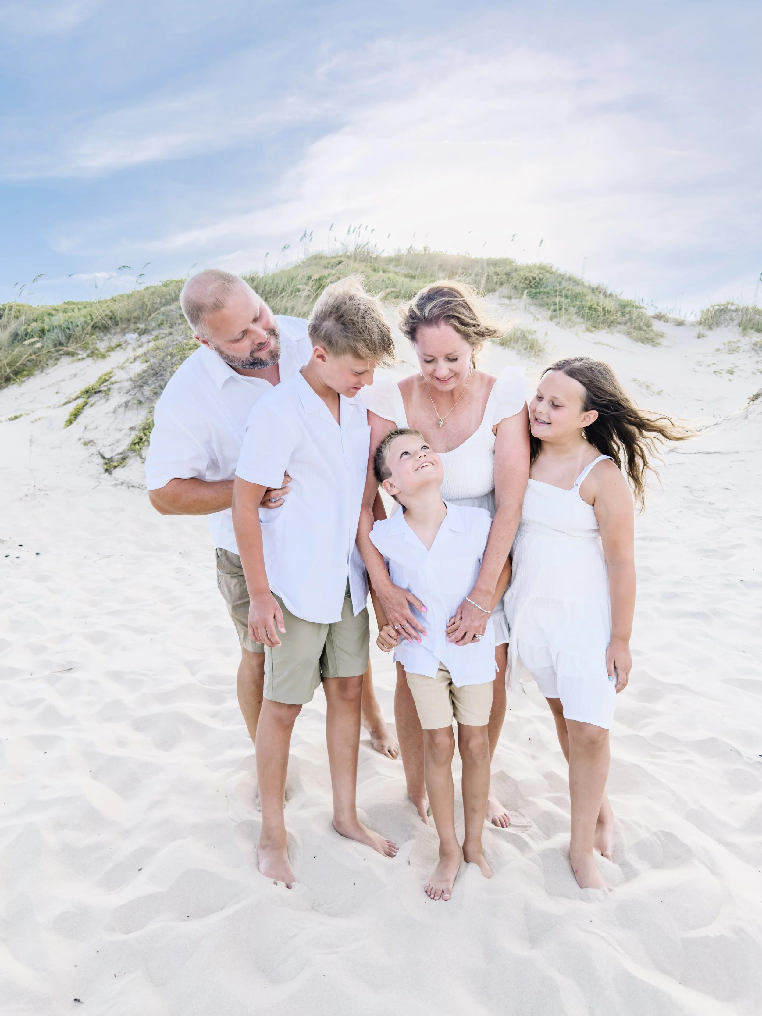 Family sharing a candid moment during a South Padre Island beach photography session