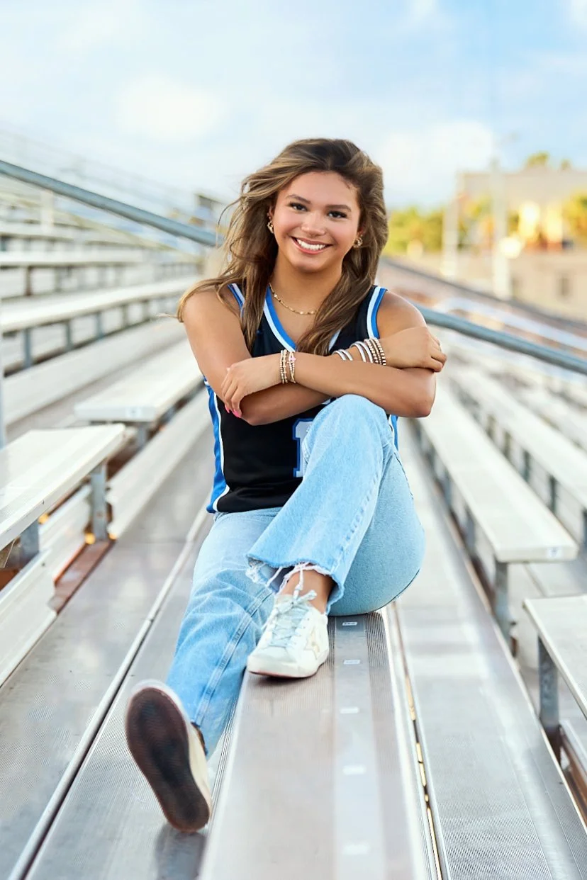 Senior portrait photographed on school bleachers