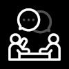 Icon of two people sitting at a table with speech bubbles overhead, symbolizing conversation or discussion.