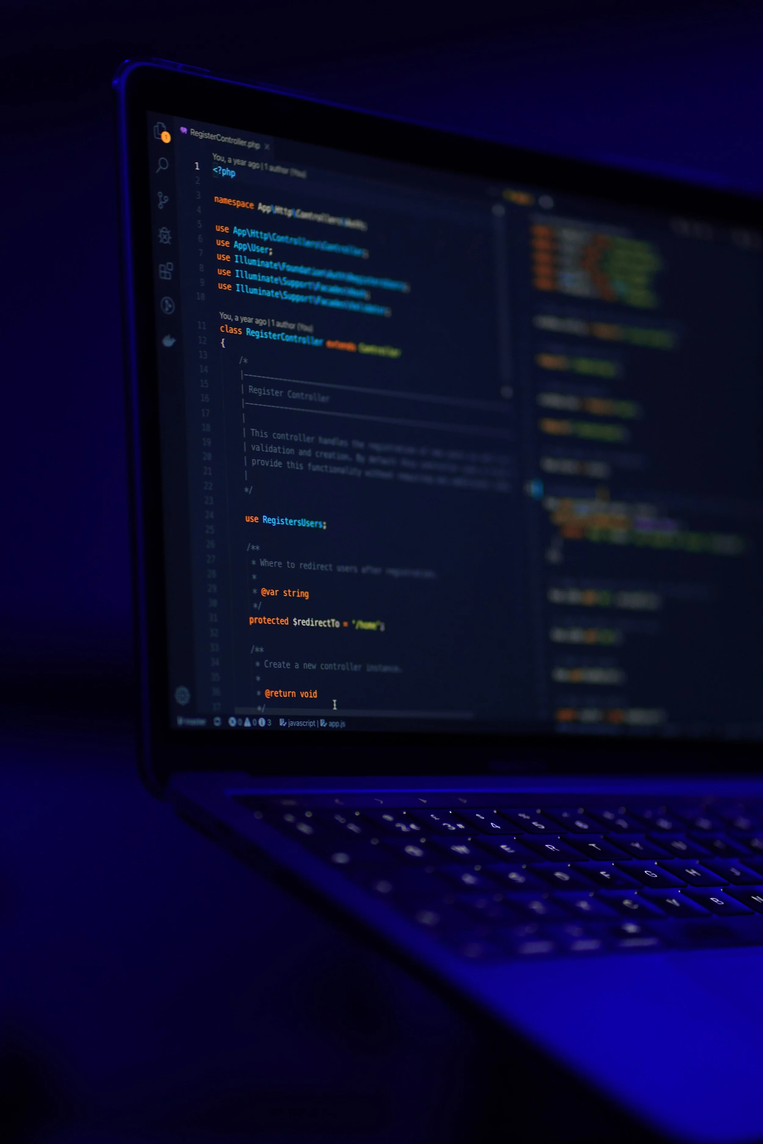 Laptop screen displaying PHP code in dark mode.