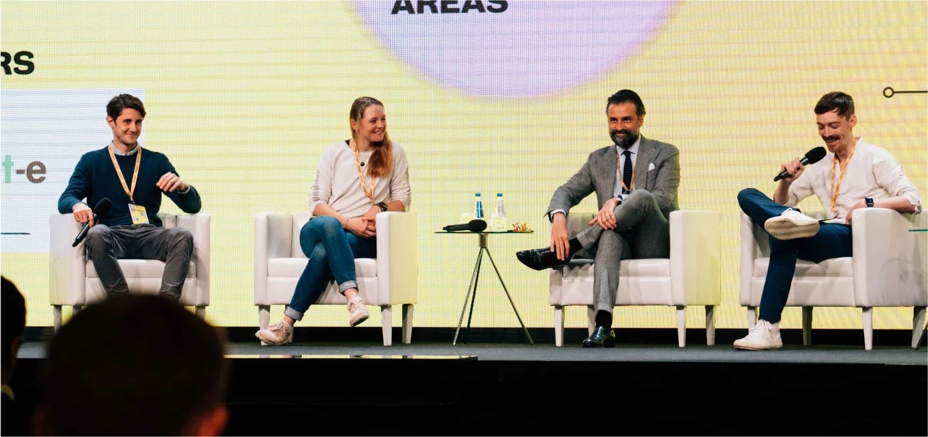 Panel discussion with four people sitting on stage