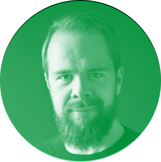 A monochromatic green circular portrait of a man with a beard and short hair, facing the camera.