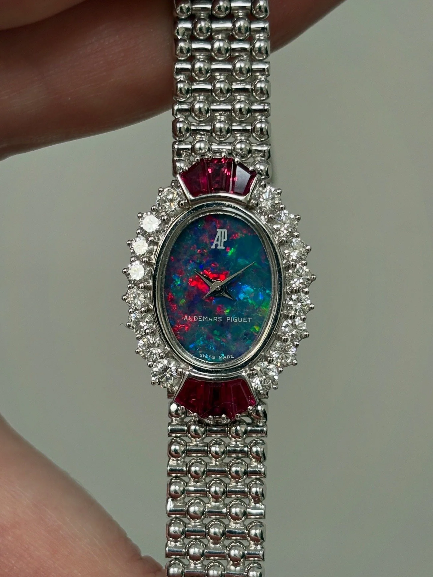 Audemars Piguet Mini Ellipse White Gold Button Bracelet, Opal Stone Dial, Diamond & Ruby Bezel ref. 79020BC w/ AP Service Paper