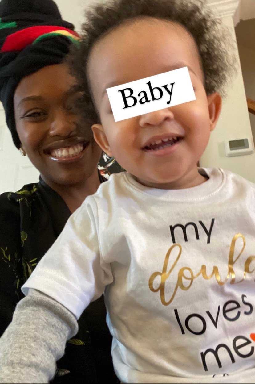 Smiling woman with headwrap and smiling toddler wearing "my double loves me" shirt