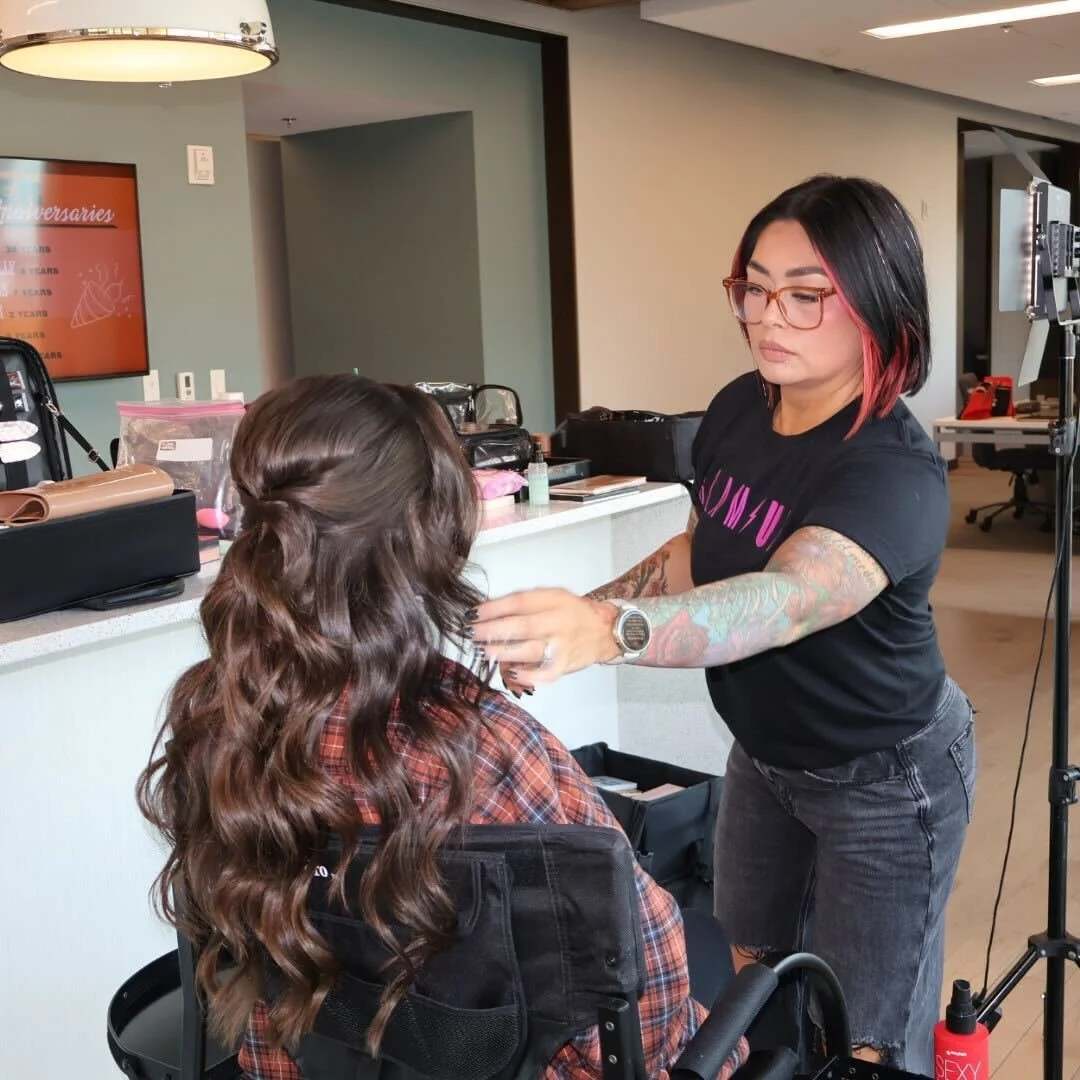 Glam Up Nashville stylist Ryanne perfecting soft glam waves on a client inside the CMA office during CMA Awards hair and makeup prep.