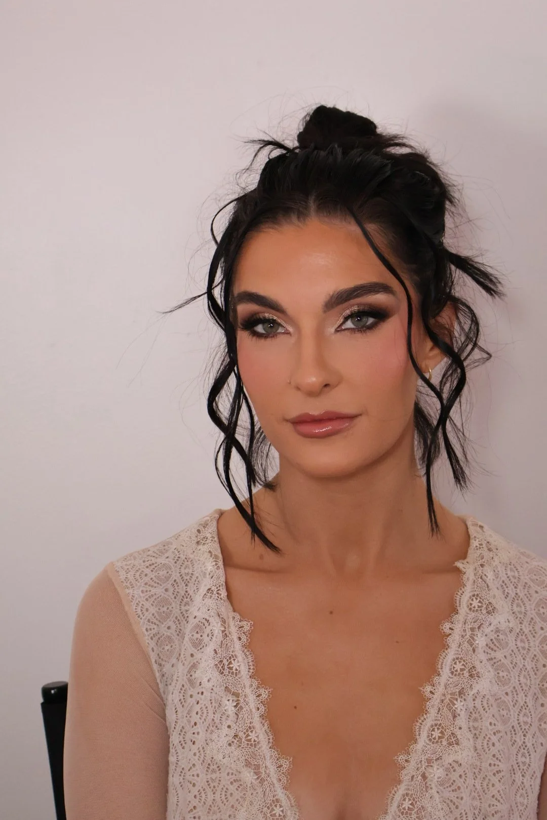 Woman with romantic soft glam makeup, rosy cheeks, glowing skin, and defined eyes during bridal beauty prep by Glam Up Nashville.