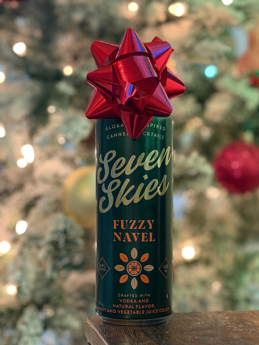 Our Fuzzy Navel is dressed for the season &mdash; bow and all.
Unwrap a little sunshine this winter and sip something sweet, bright, and perfectly giftable. ✨🍹

Cheers to holiday vibes, Seven Skies style!
#naturalflavor #nofizz