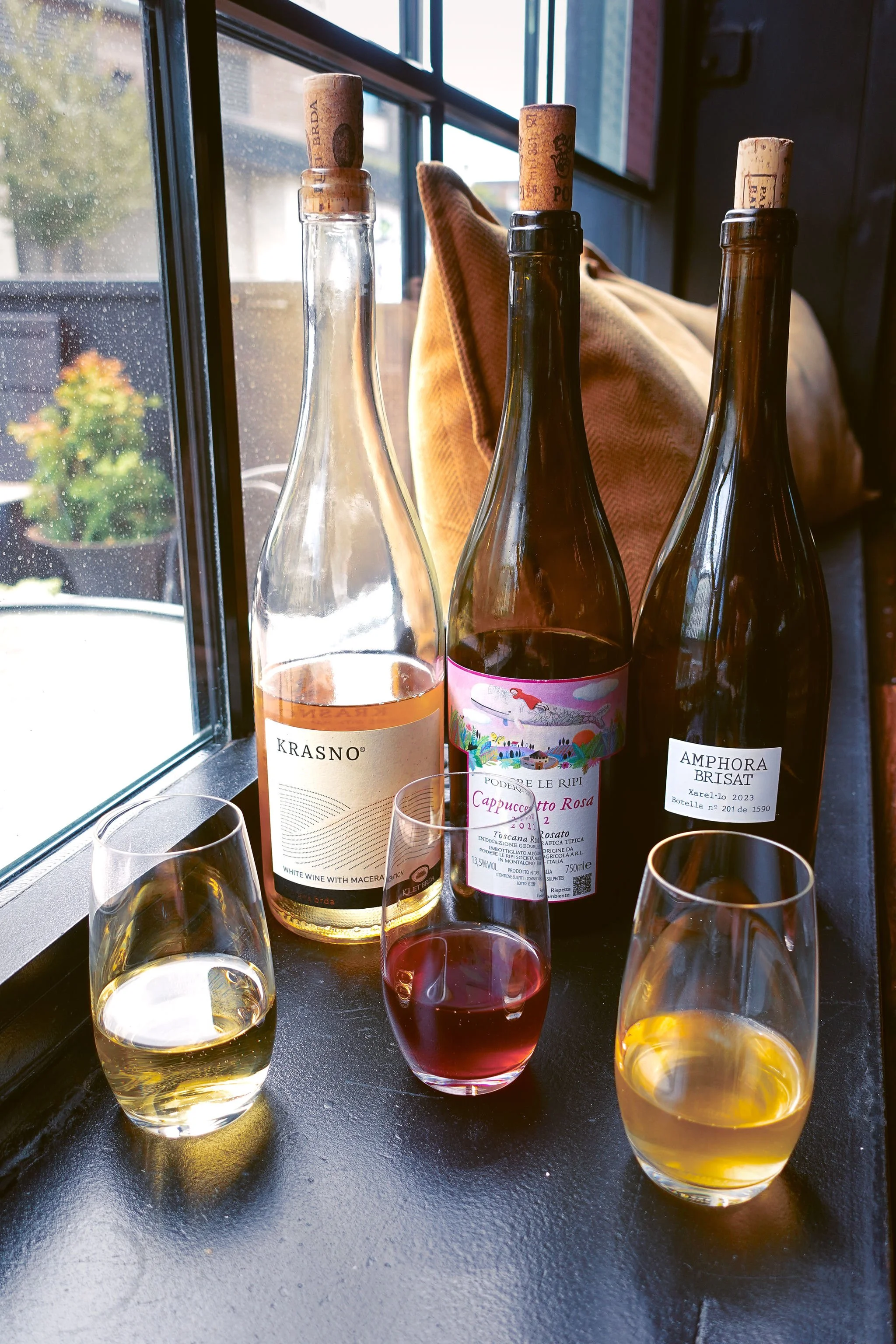 Sommelier selected wines for a seasonal wine flight. Wines include: Slovenian Skin Contact, Spanish Xarello Amphora Brisat,  Sangiovese Rosato from Tuscany