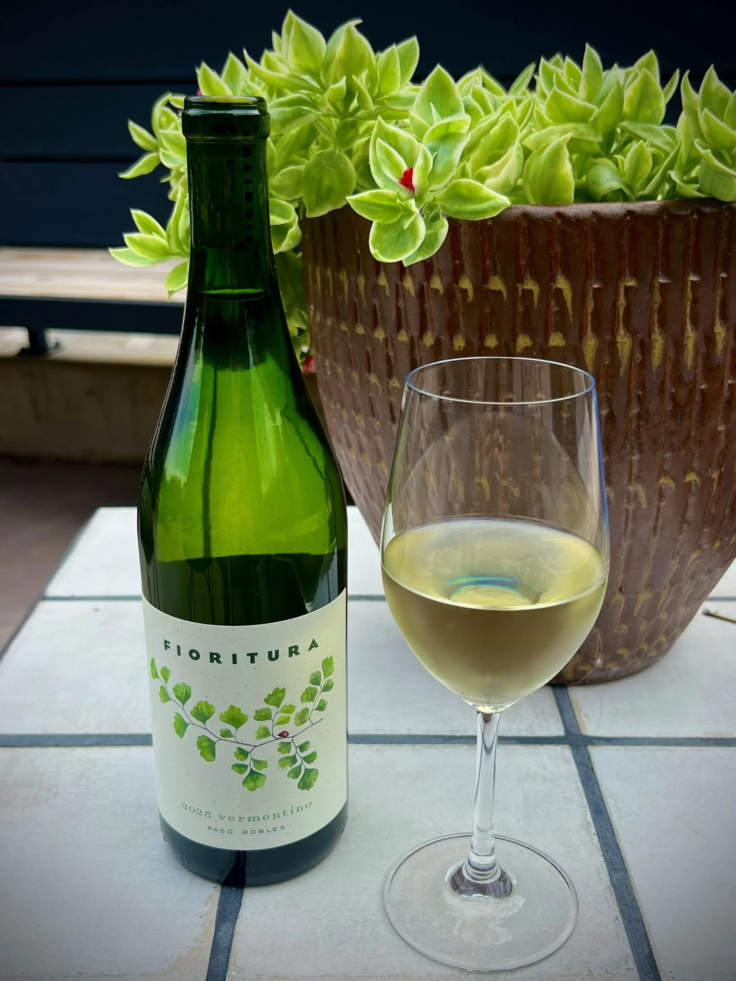 Vermentino from Paso Robles. Glass of white on a patio outside in the Post District of Salt Lake City, Utah.