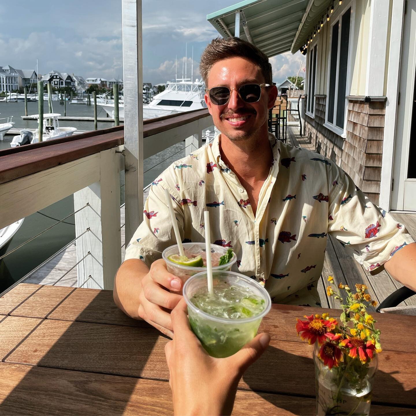 Cheers from our front porch with some fresh cocktails! #AintLifeGrand #MarinaViews #SunsetBar #TheWispBHI #BHI #Cheers