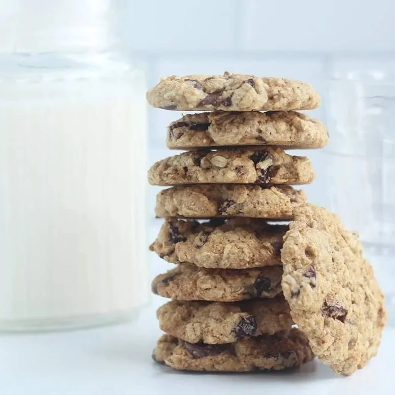 Glass of milk and a stuck of chocolate chip oatmeal cookies