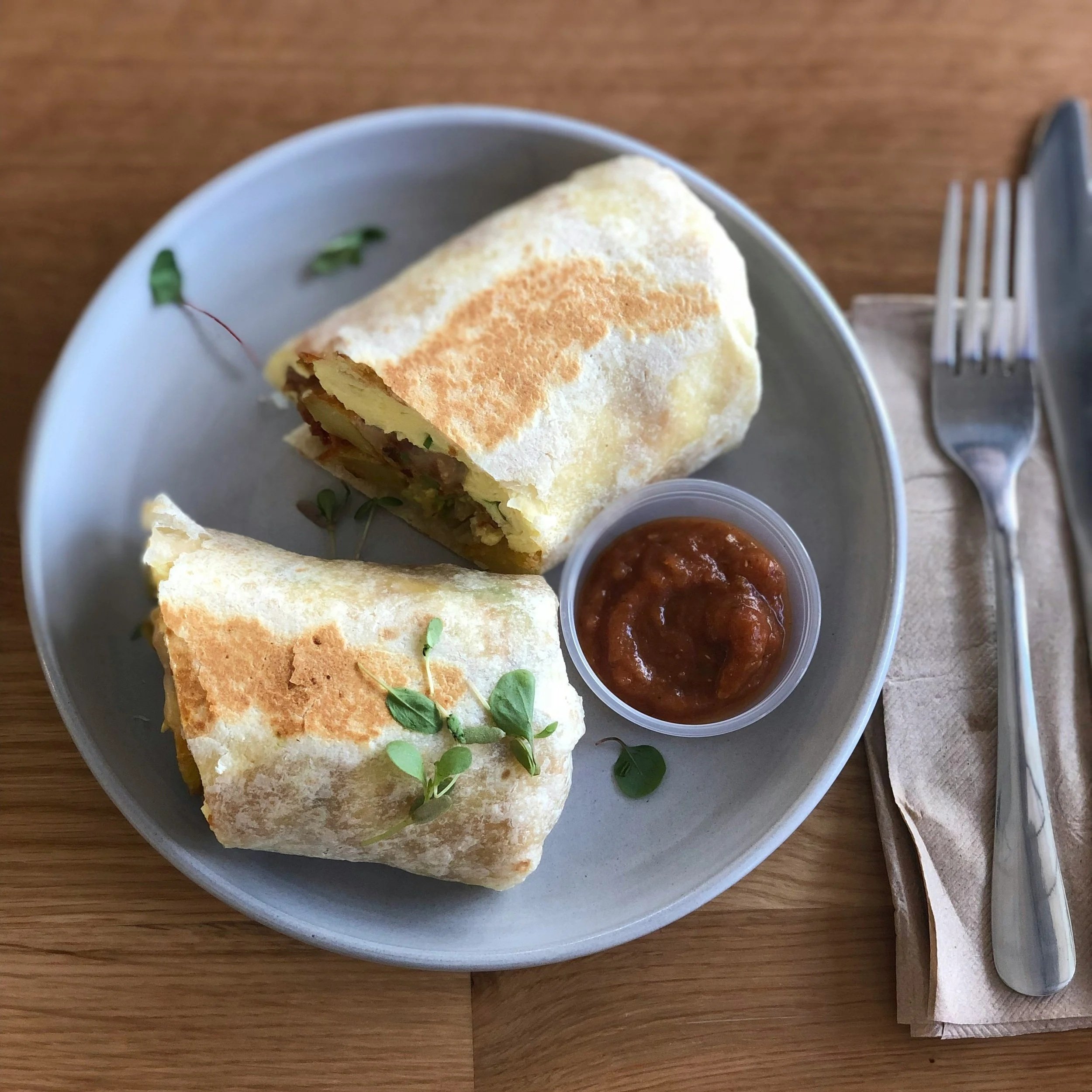 breakfast burrito with salsa on a plate