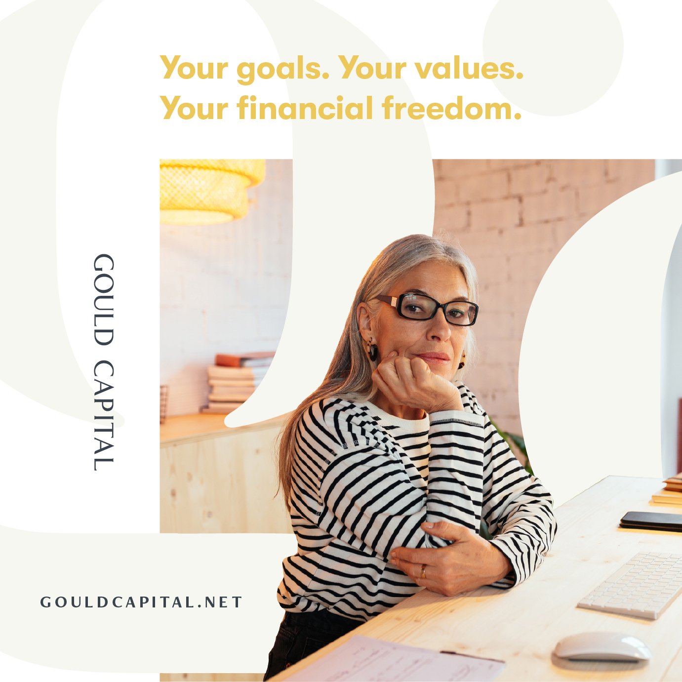 A woman with gray hair, glasses, and a striped shirt sitting at a desk with a keyboard and mouse, with promotional text about financial goals and values, and Gould Capital branding.