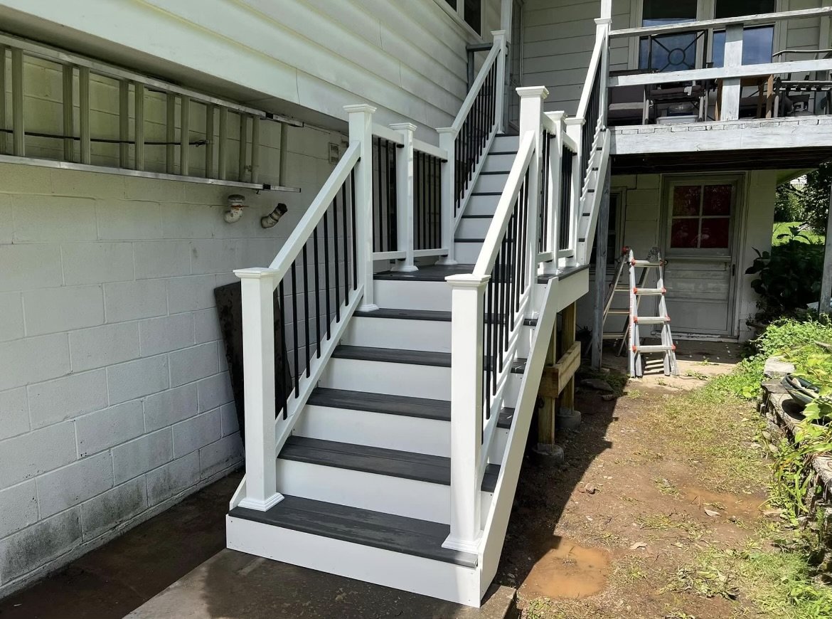 Trex Clam Shell boards with white Trex rails. 12 step staircase with an intermediate platform. for safety.