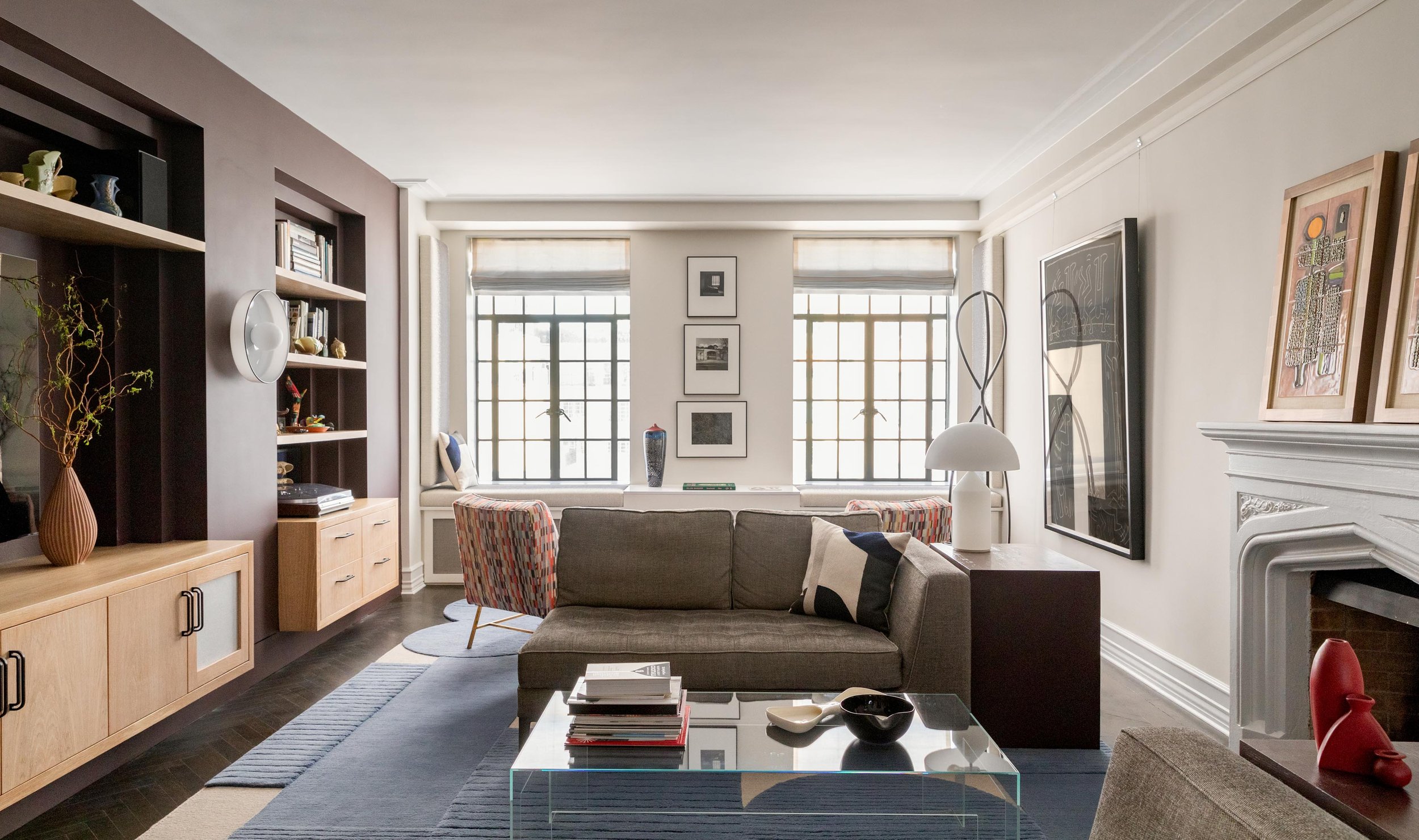 Living room renovation with original steel windows, new custom millwork, and new furnishings. Photography by Nicholas Venezia.