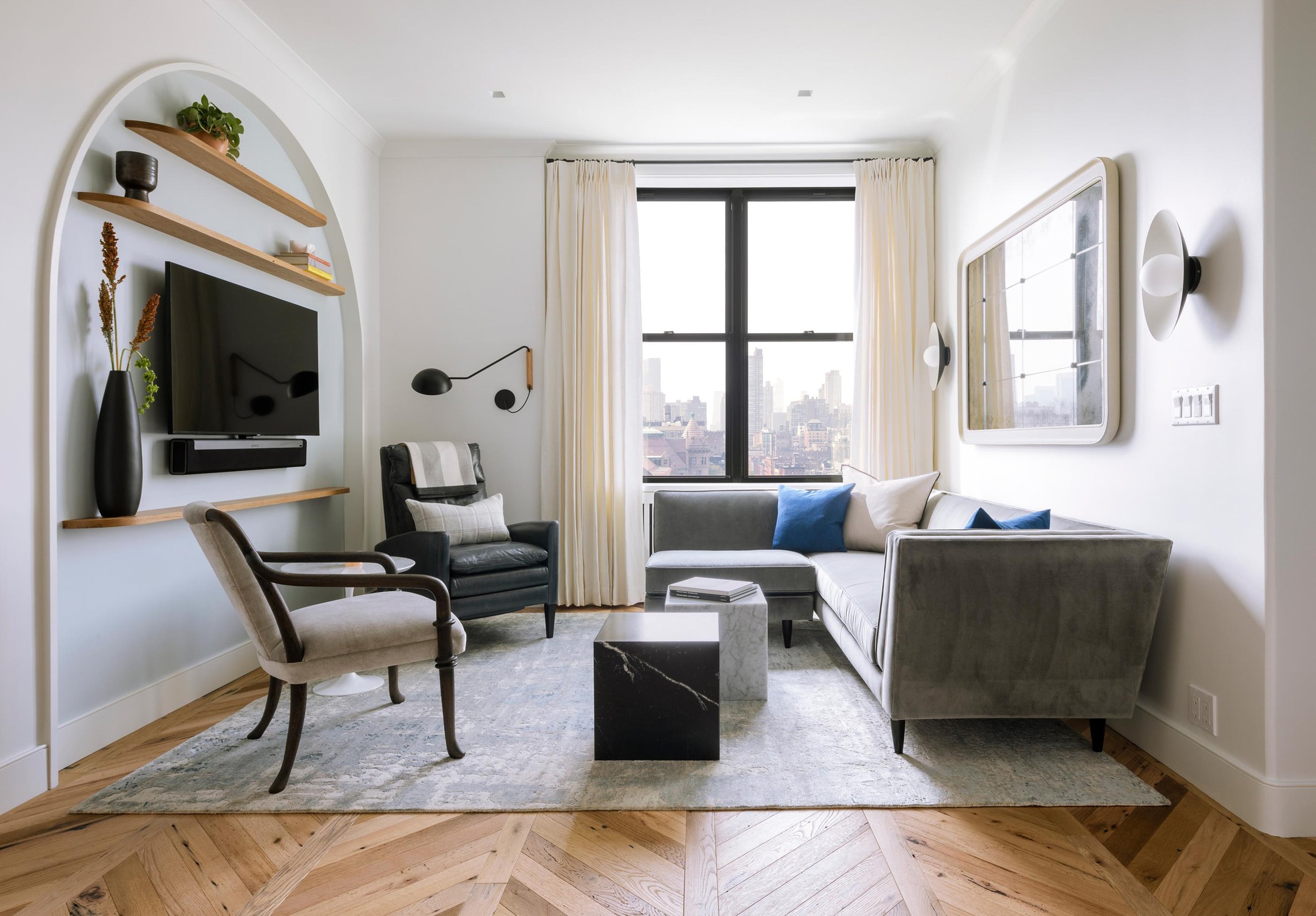 Living room renovation with arched niche, custom shelves, and new reclaimed oak flooring. Photography by Nicholas Venezia. 