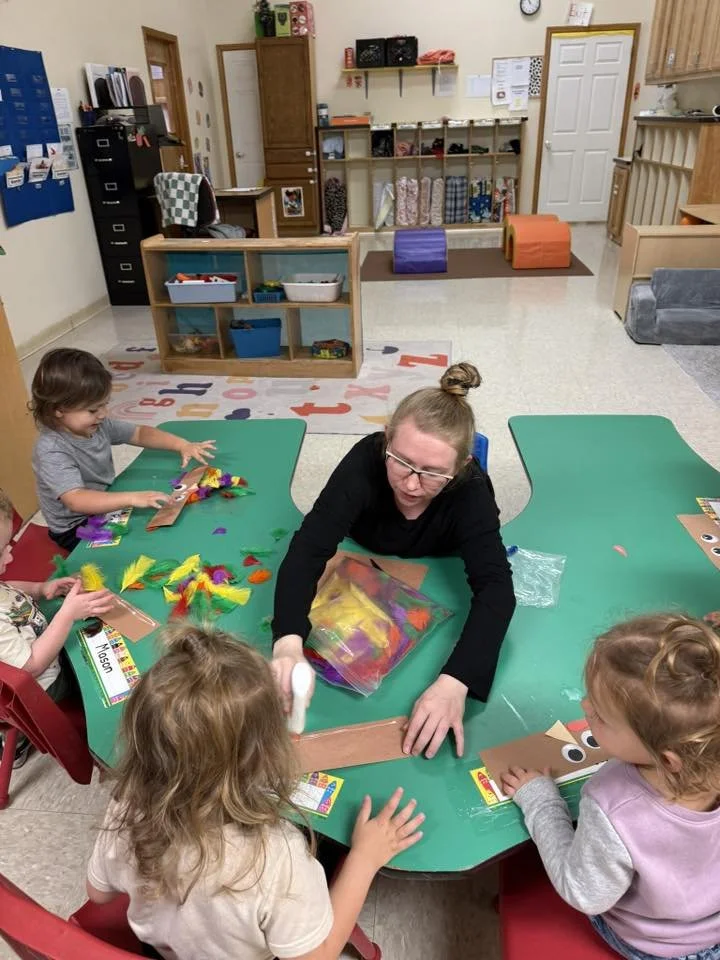 GF teacher with class doing Turkey crafts.jpg
