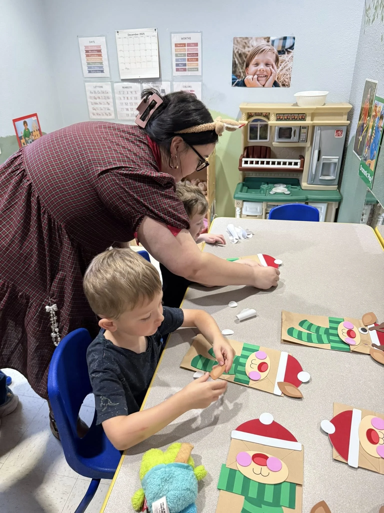Huntsville 2026 Jan teacher helping with crafts.jpg