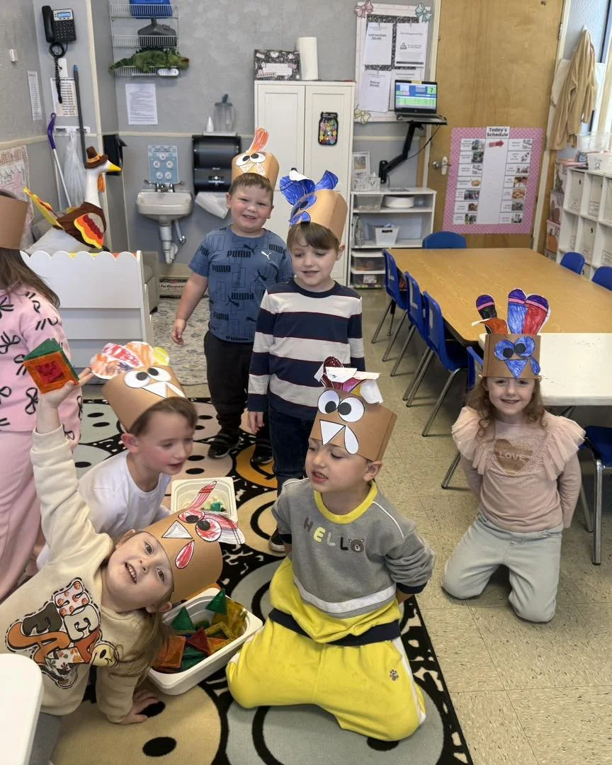 Harrison Mrs Becky's class with turkey hats.jpg