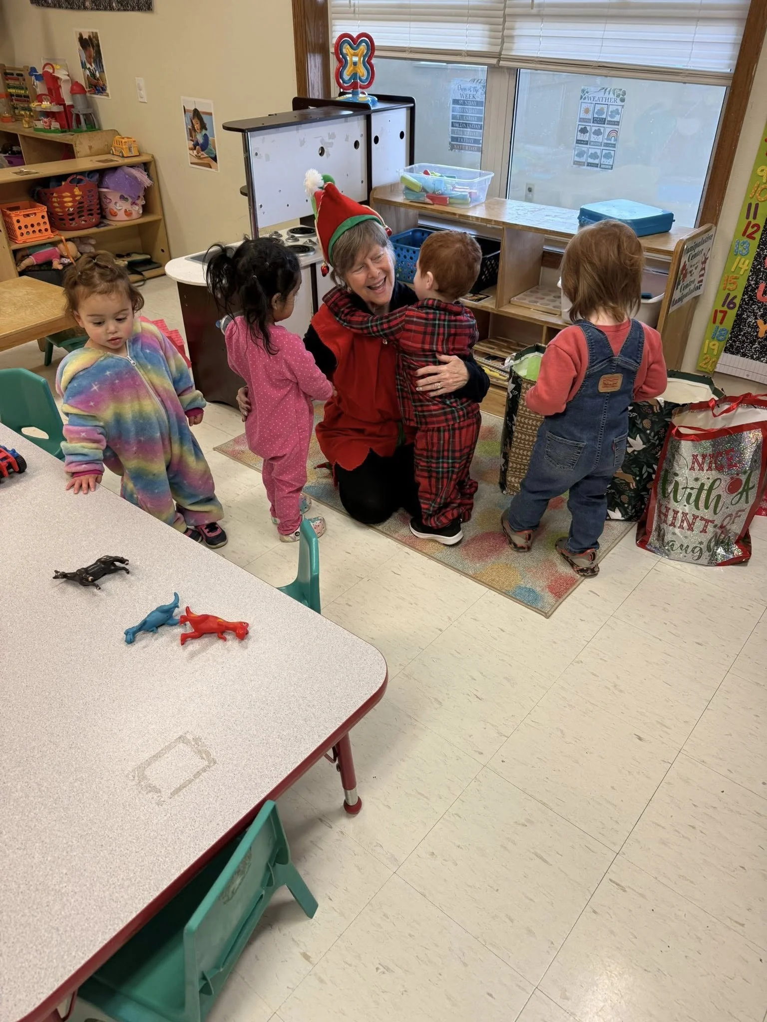 BV 2026 Jan elf getting hugs from kids.jpg