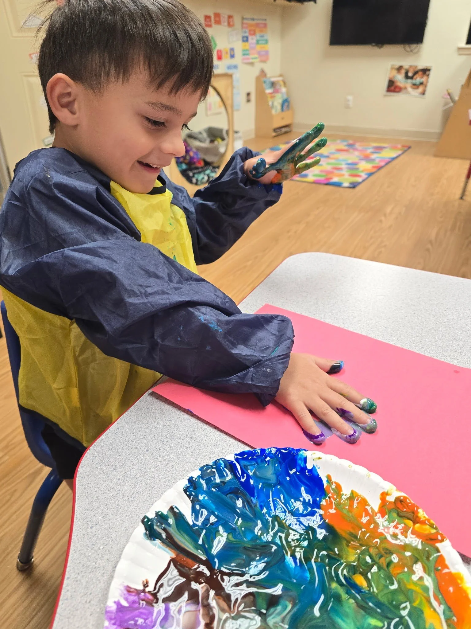 Alpena Aug 2025 boy finger painting.jpg