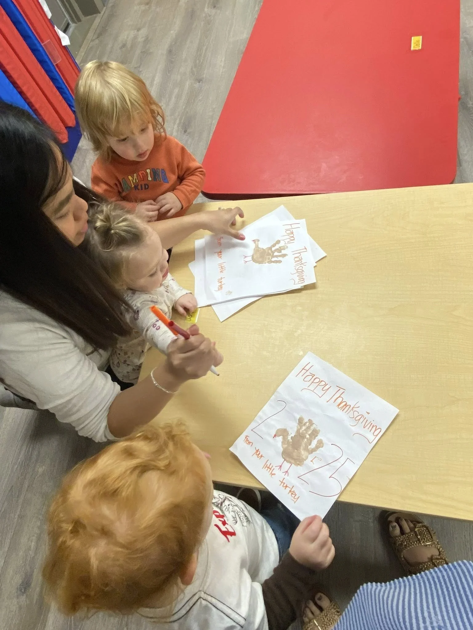 Harrison teacher writing with toddlers.jpg