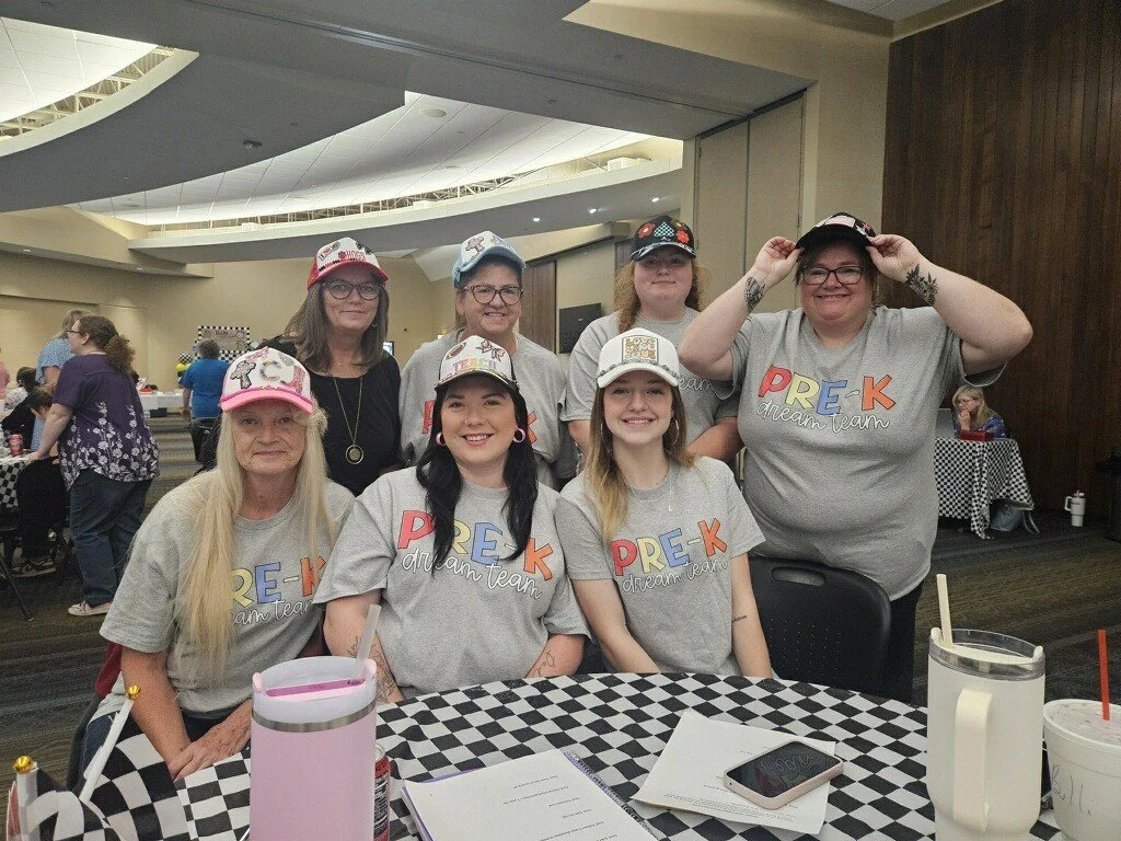 Huntsville staff with hats shirts.jpg