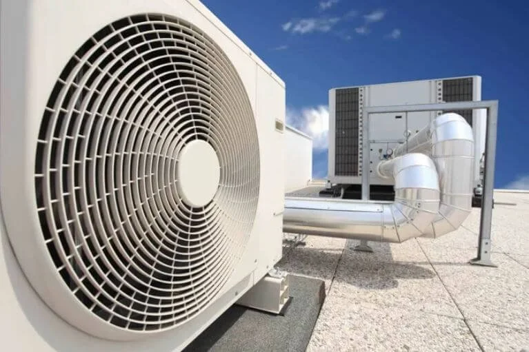 A large commercial hvac unit and ventilation installation on the rooftop of a business