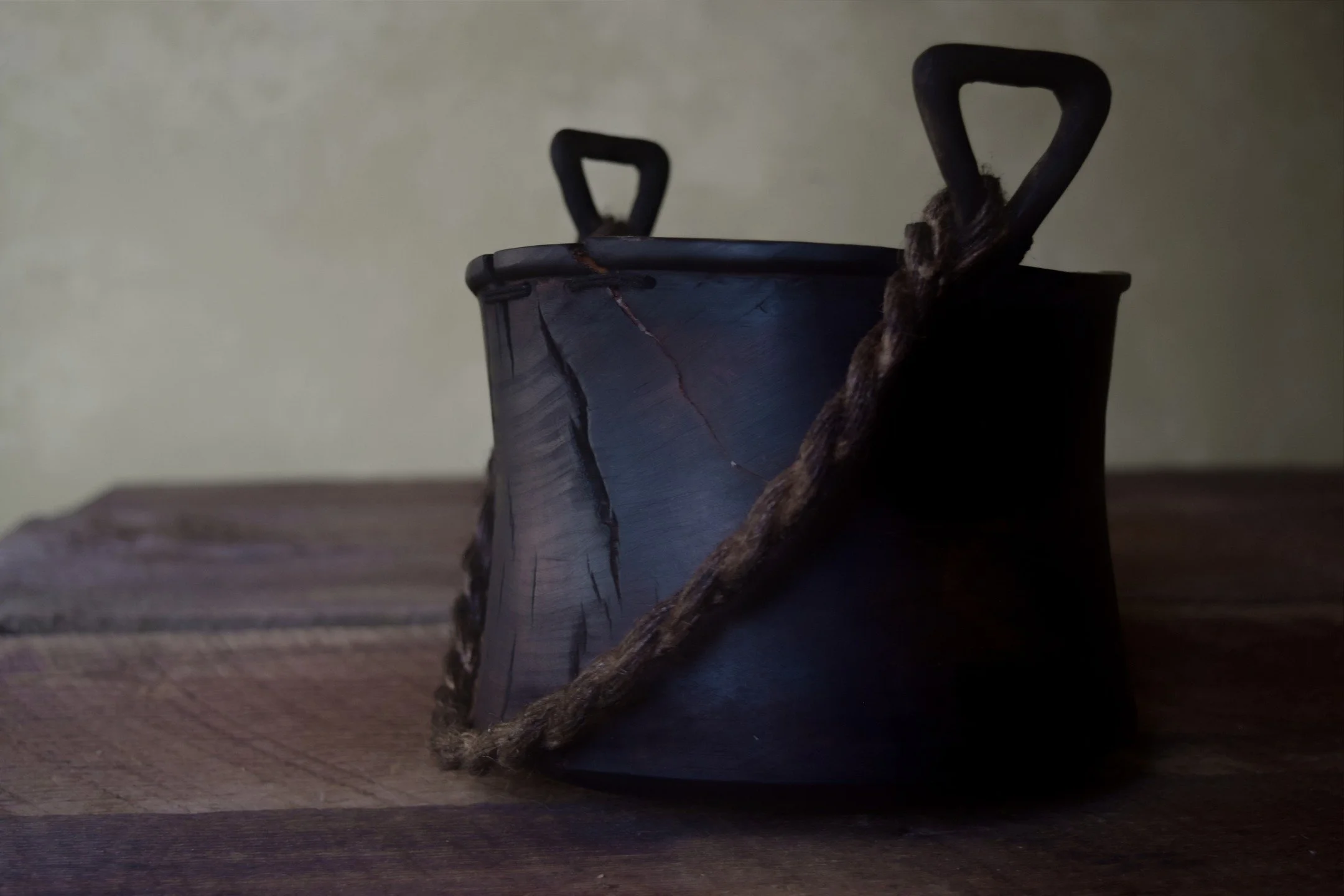 Galley Bucket 

Another vessel incorporating a rope element, this bucket has some intricately carved and wrapped handles that anchor the aged Jute. While the shape is quite simple, the lipped rim and vertical handles posed some carving challenges but
