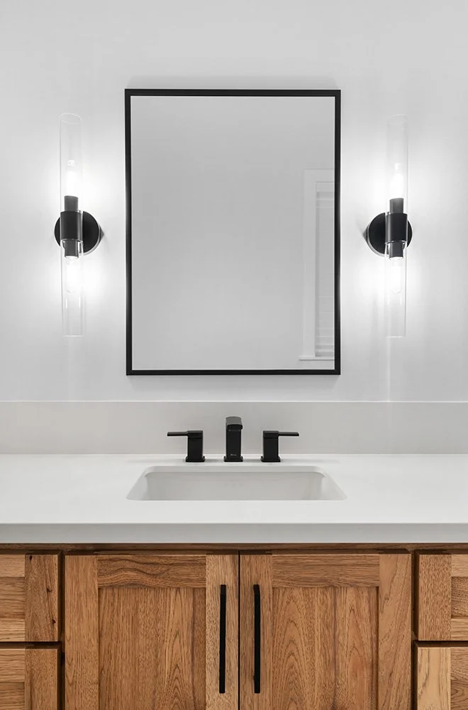 wood bathroom vanity with black fixtures