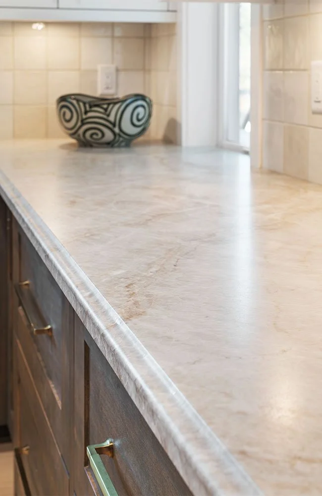quartzite countertops with walnut cabinets