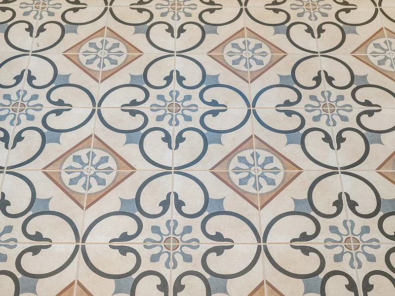 Ornate tile design square tiles on the floor cream and light blue repeating tile design