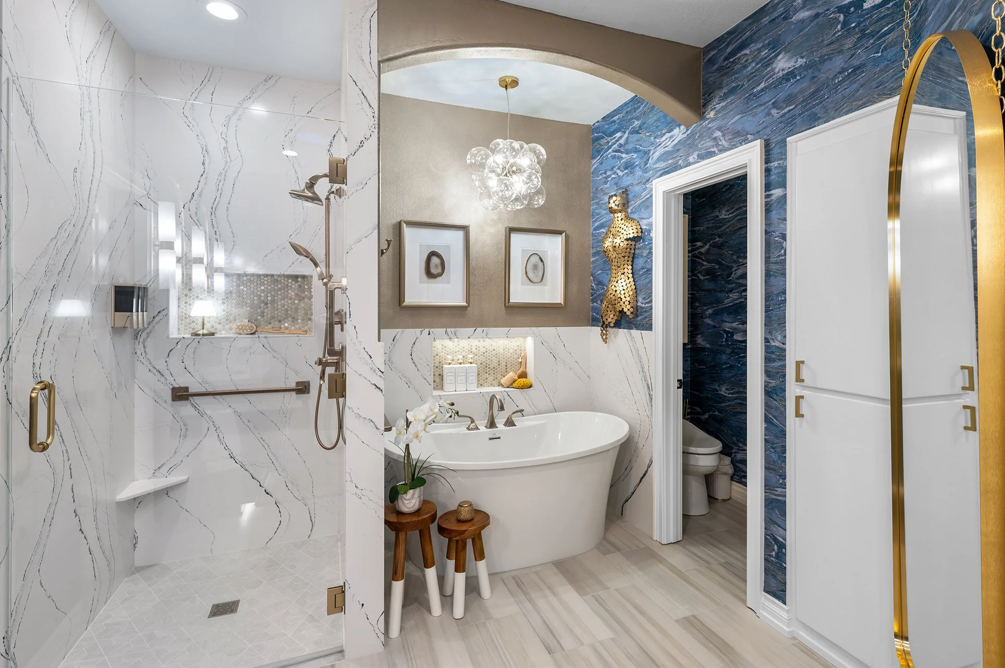 a modern bathroom update with white tile work and blue and gold accents in a Redding home