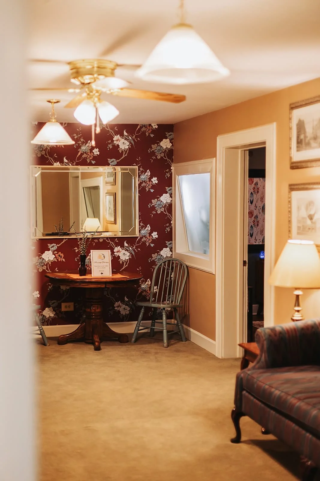 The waiting room at Jessi Osborn LMT, charming, quaint, floral wallpaper