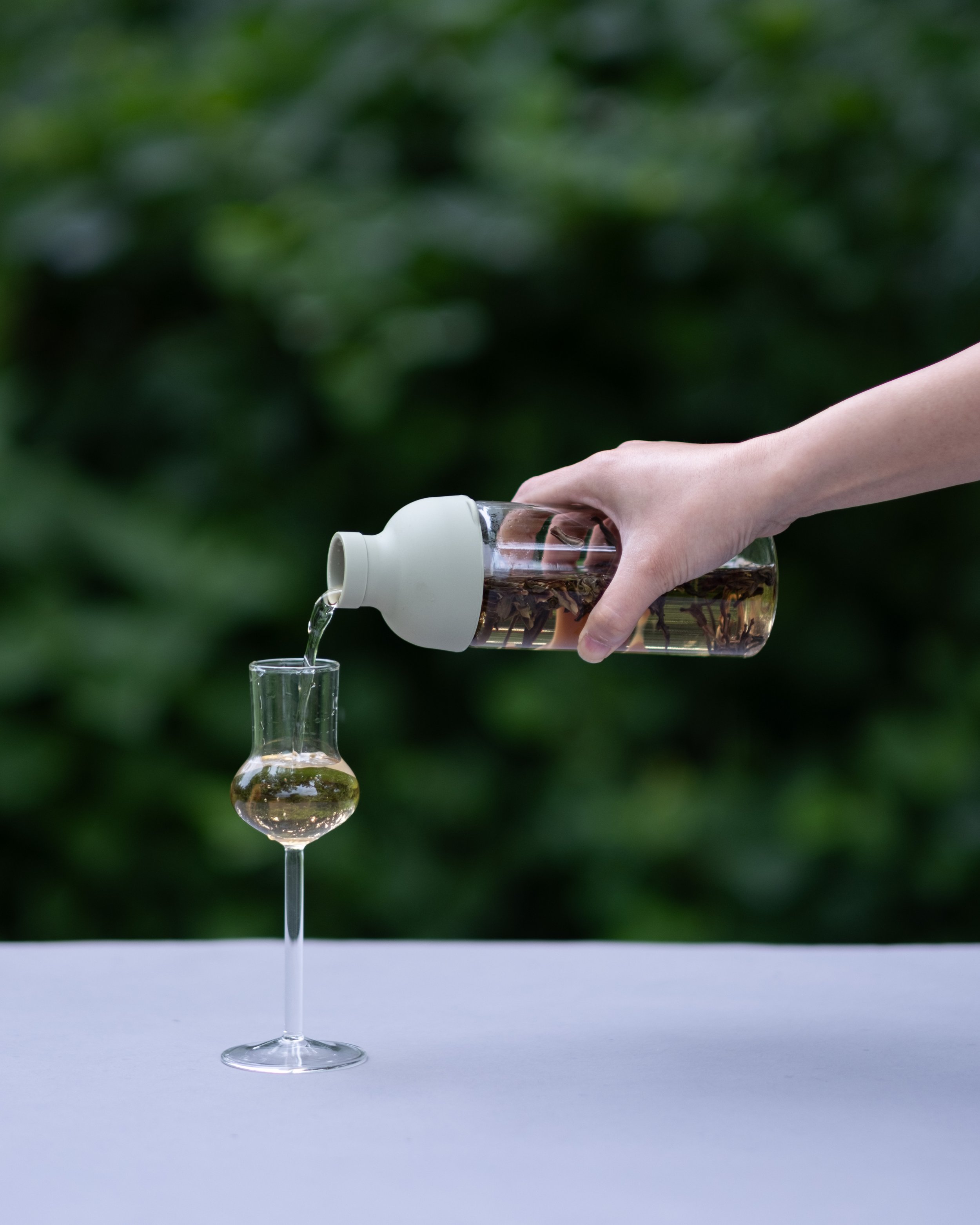 Cold-brewed Chinese tea being poured into a glass cup for the Summertime Tea Collection