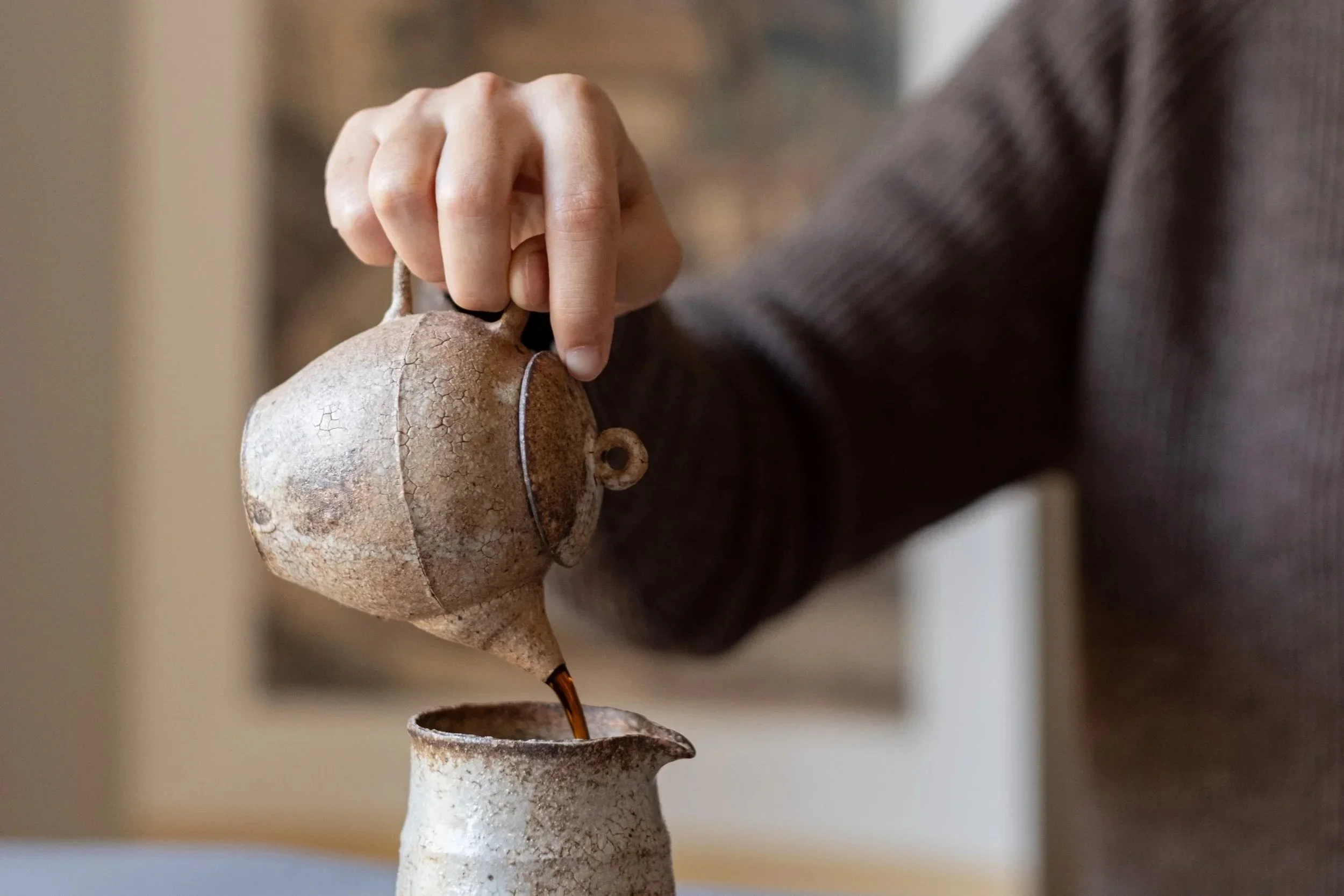 Tea is poured from a clay teapot into a faircup during a Chinese tea tasting at Teasthetic.