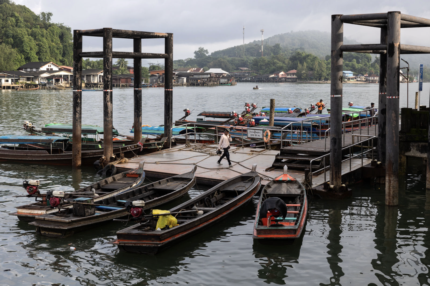 A man arriving by boat at Ranong's immigration border crossing, a key entry point for Burmese workers entering Thailand.