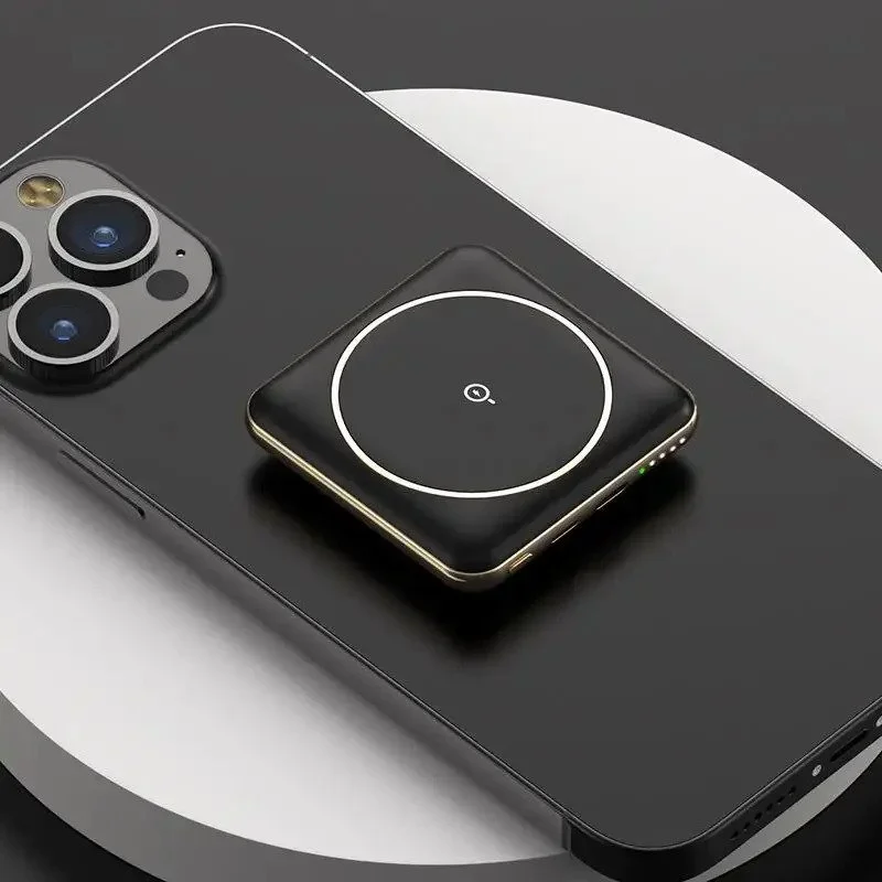 Close-up of a smartphone with a wireless charging pad on its back, placed on a surface with a curved design. The phone has three rear cameras and an LED flash.