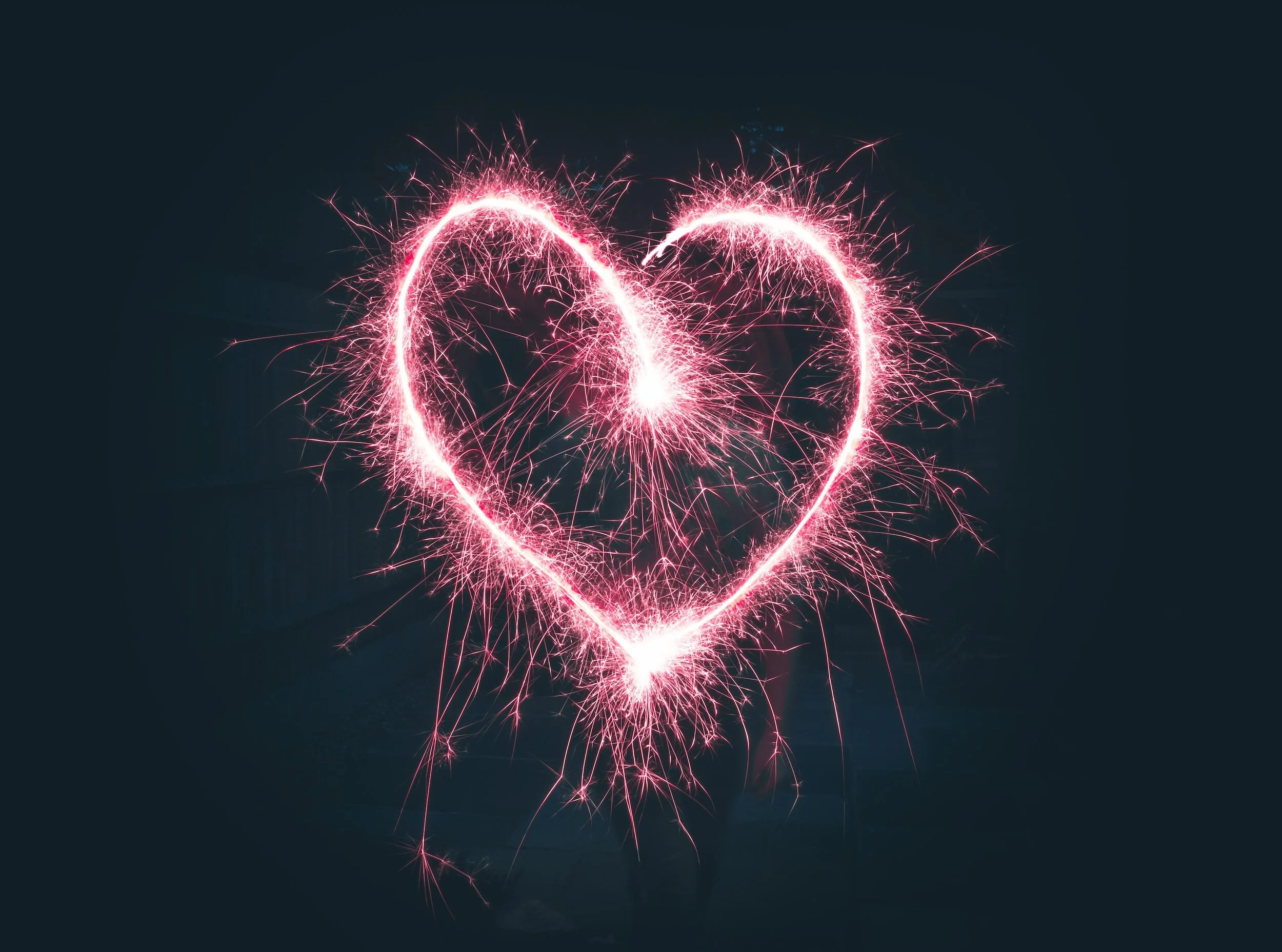 Pink sparklers drawing a heart