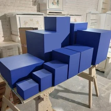 Set of coloured display plinths