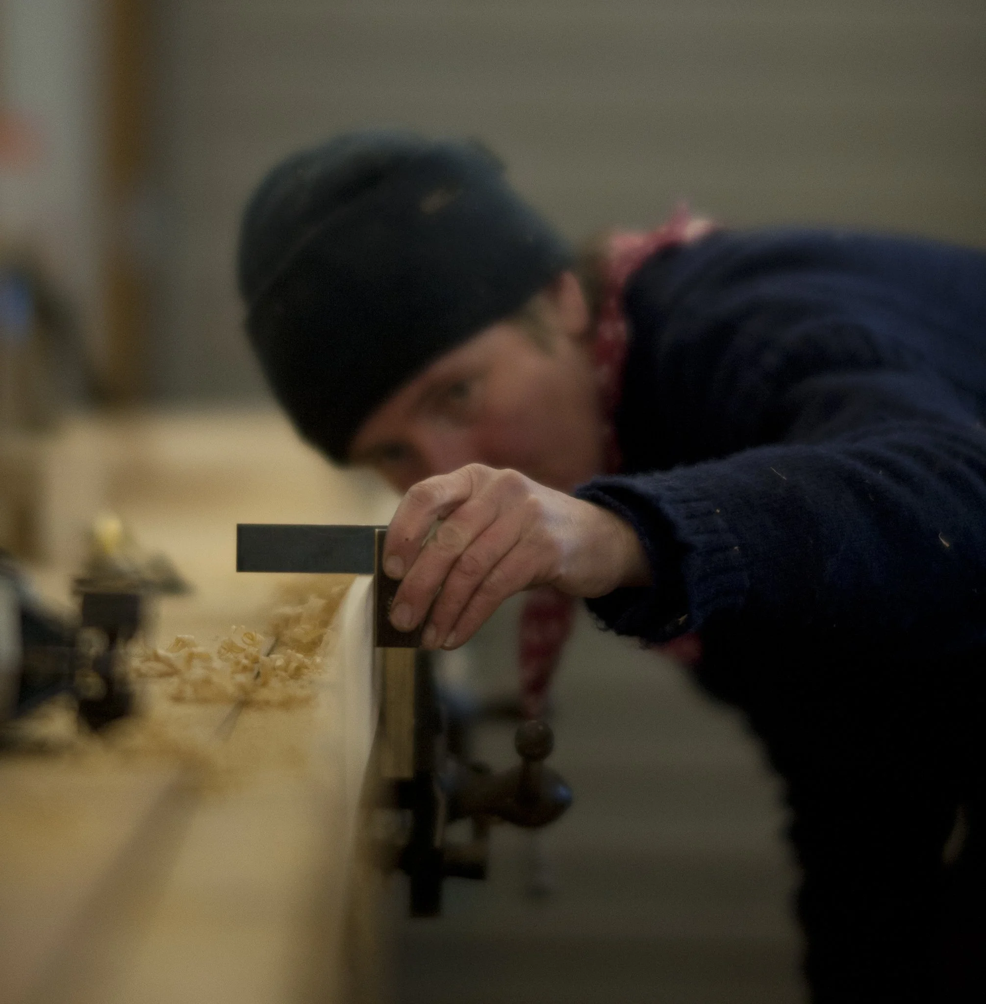 Gail McGarva, master boat builder in Lyme Regis, Dorset, using carpenter's square on piece of timber