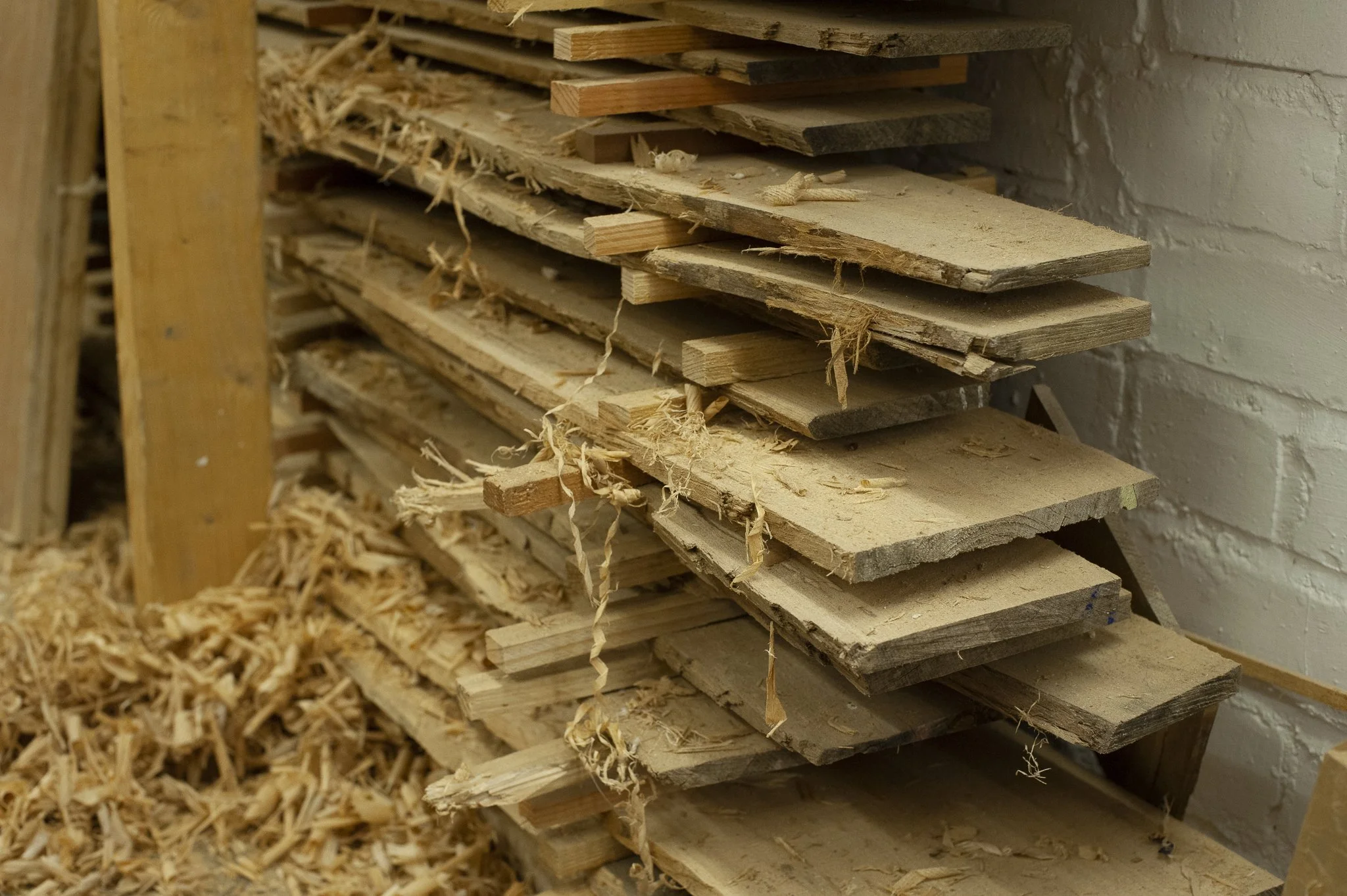 Piles of stacked timber in a workshop