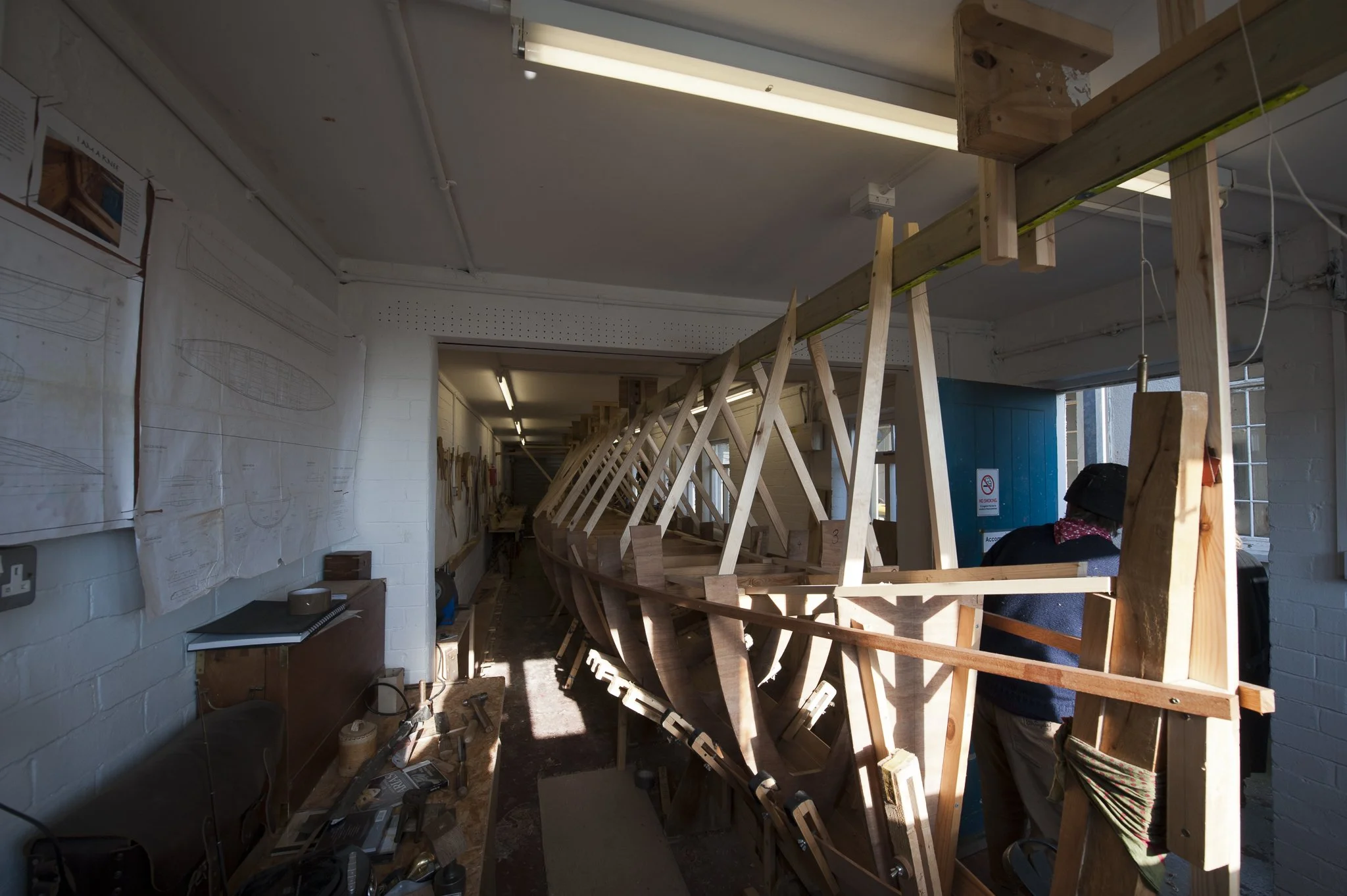 Professional commercial photography of gig boat being built in workshop by Gail McGarva