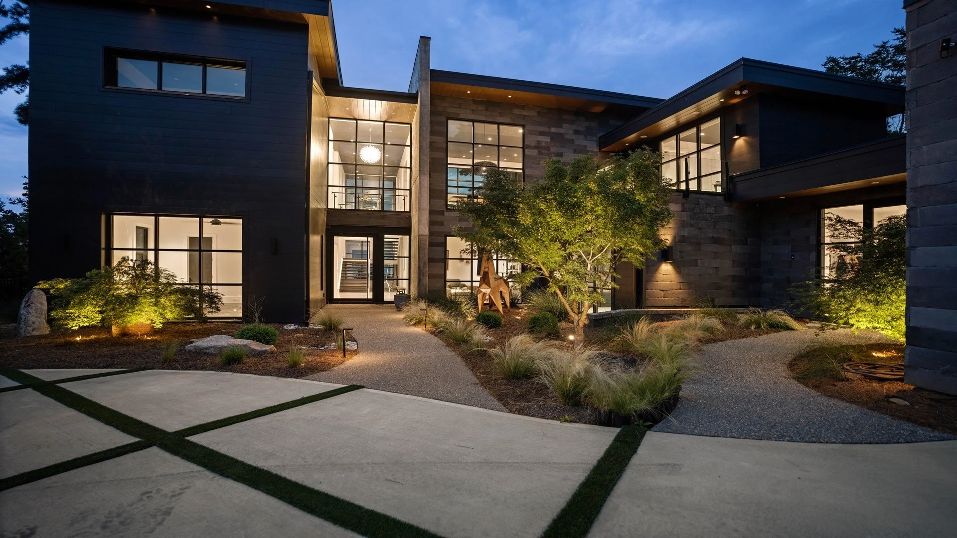  Entryway & Garden Lighting 
A modern home’s grand entrance illuminated with garden lighting, walkway lighting, and exterior accent lighting. Carefully placed lights highlight architectural details, trees, and pathways, creating an inviting and secur