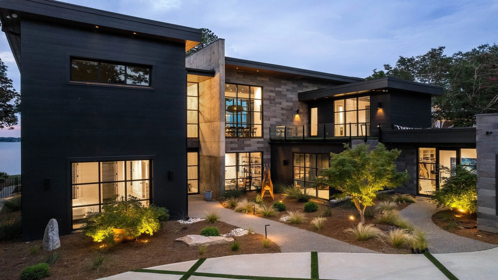  Architectural & Pathway Lighting 
Contemporary home featuring architectural lighting, pathway lights, and landscape uplighting. Strategic lighting enhances the home's exterior design, guiding guests along the illuminated walkway and accentuating the