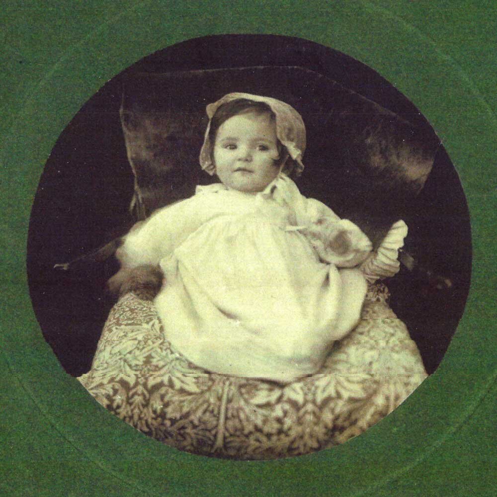Baby Catherine Cockerell on a William Morris cushion