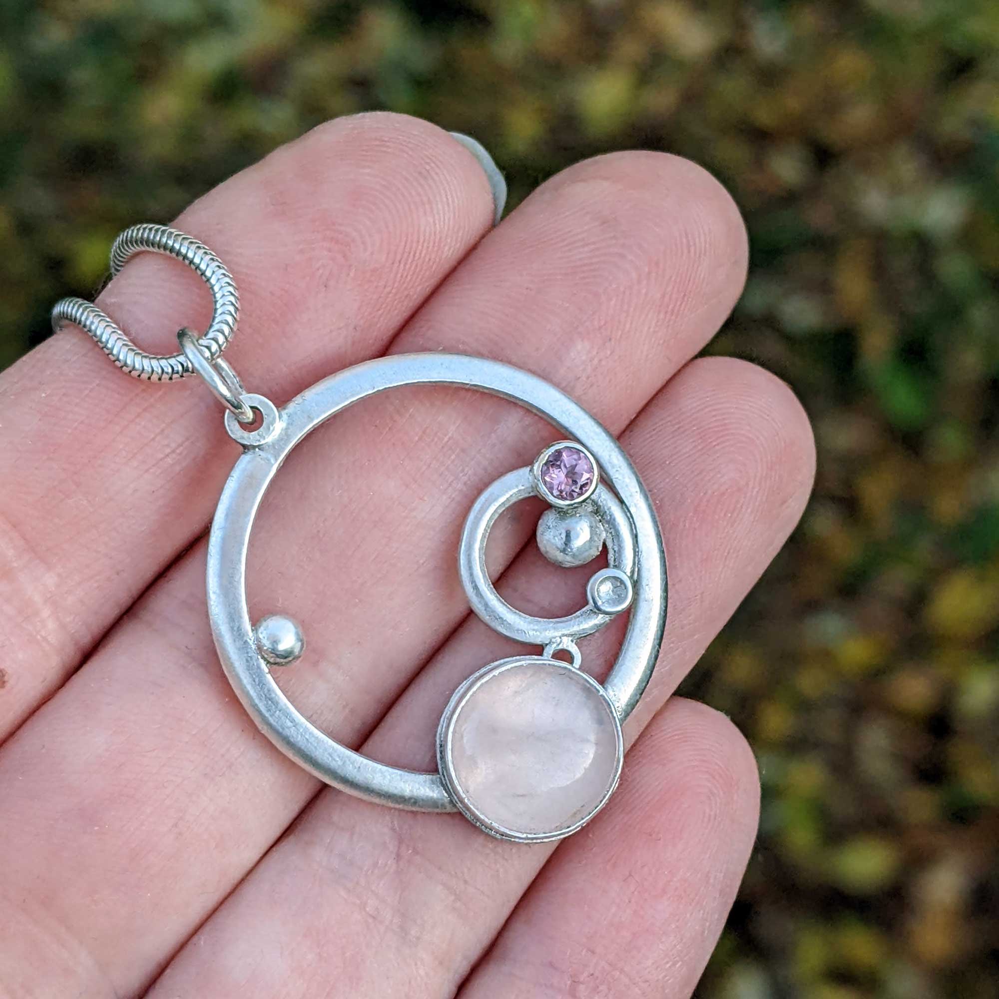Rose_Quartz_pink_tourm_circles_pendant_hand_.jpg
