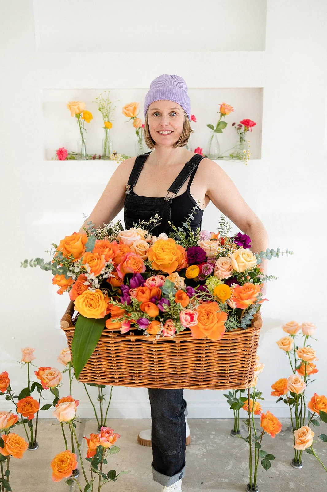 florist holding basket filled with flowers