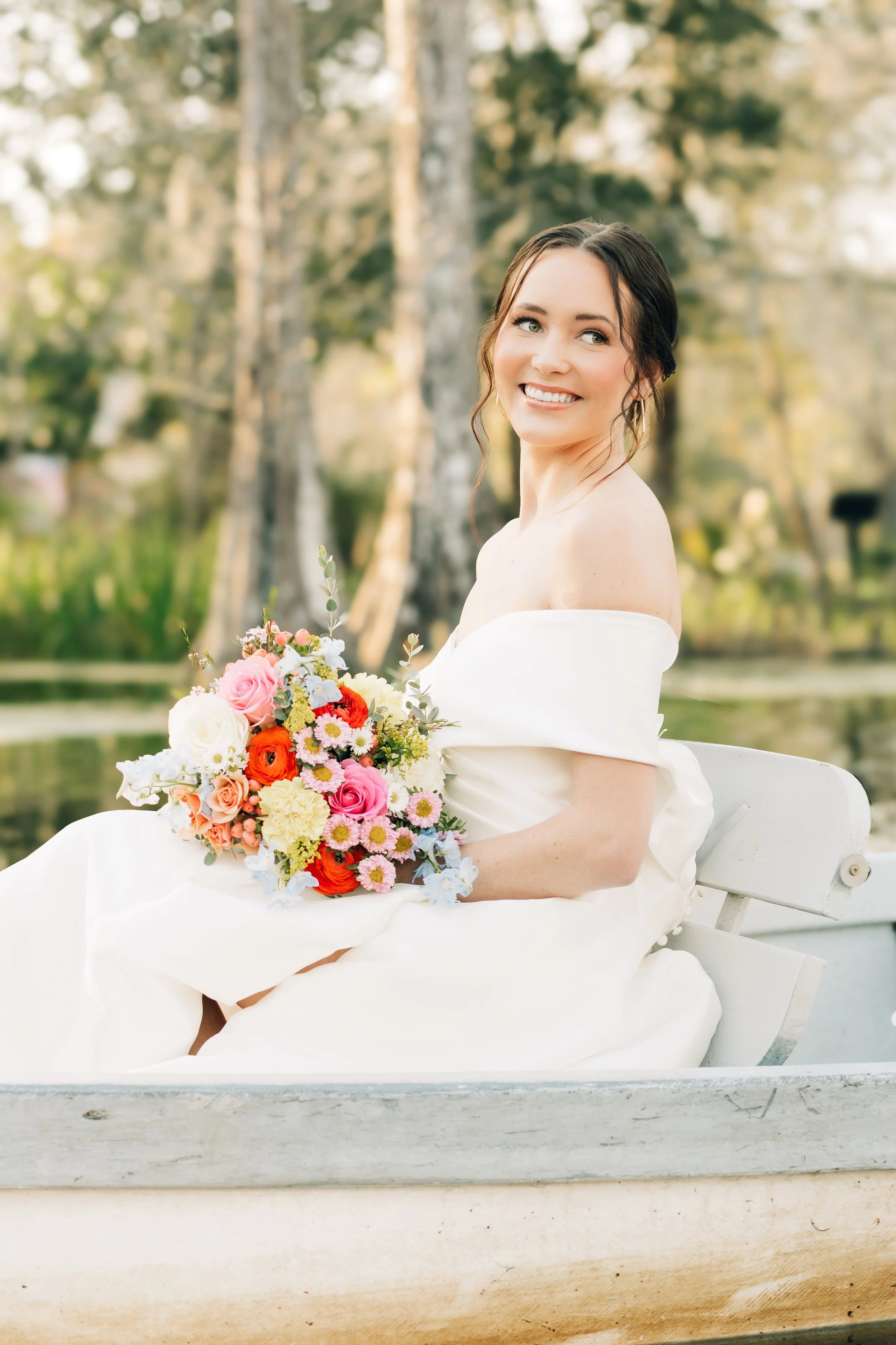 Elegant bride seated with floral bouquet at Charleston wedding — destination wedding photography