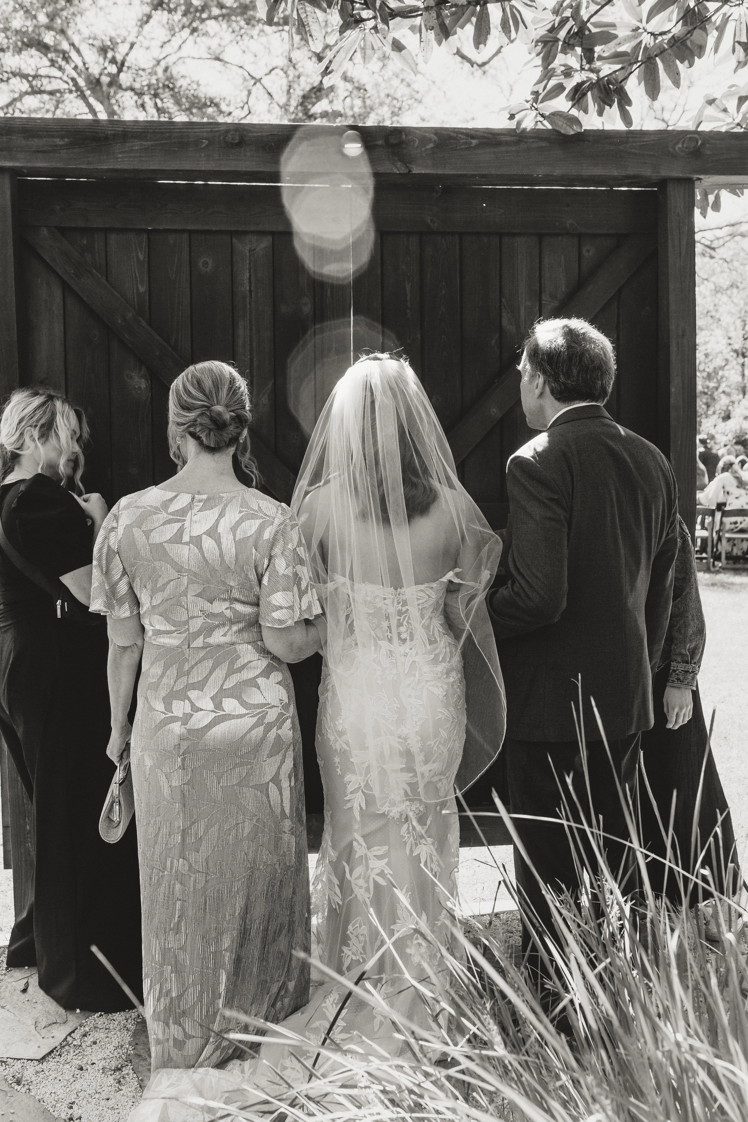 Black and white wedding photograph capturing joyful post-ceremony moment
